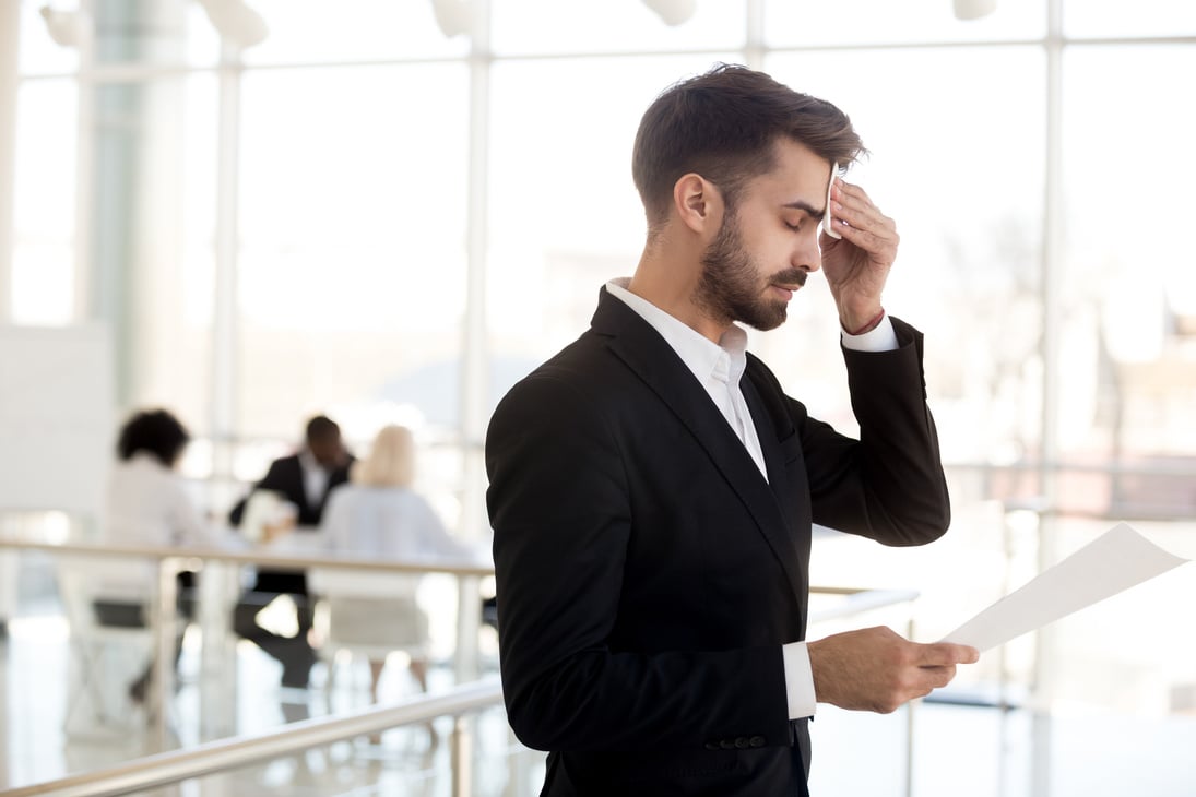 Sweaty nervous businessman wiping forehead afraid before public speaking